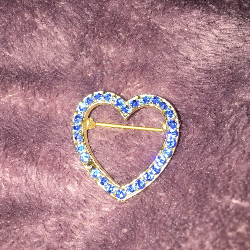 a heart pin, one of the rhinestones are missing